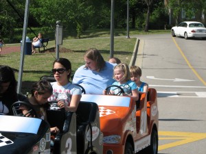 Taylor and Elizabeth ride the race car train at the Magnolia Festival
