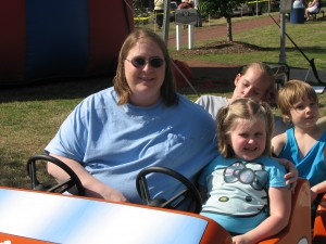 Taylor and Elizabeth ride the race car train at the Magnolia Festival