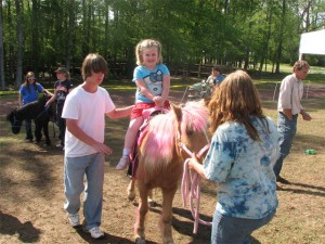 Taylor takes a ride on the pink pony at the Magnolia Festival
